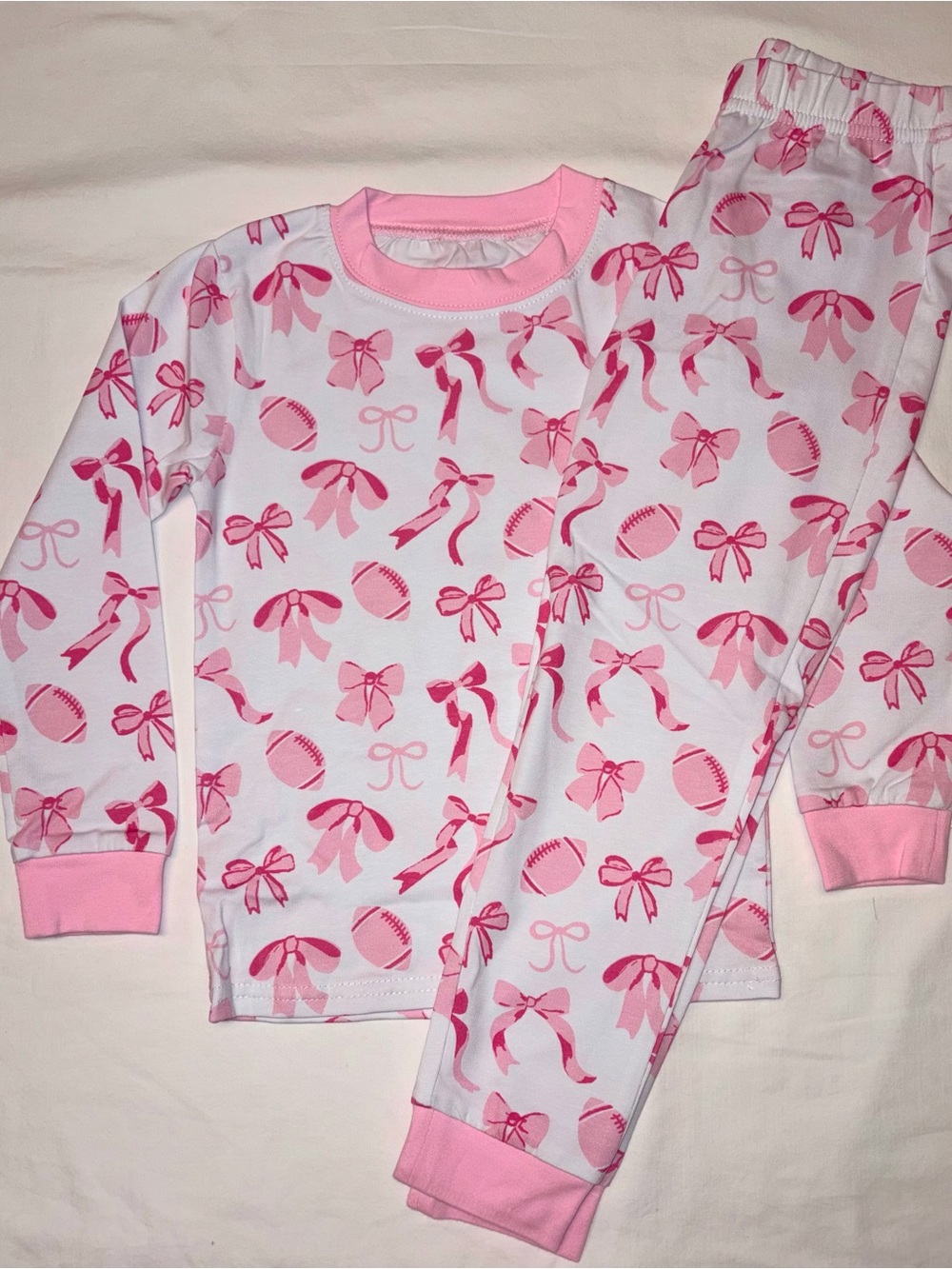 Cecil and Lou pajamas set featuring football and bows sz 4T NWT